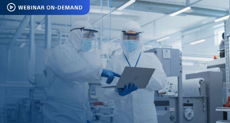 Webinar On-Demand: Photo of two workers in cleansuits in a manufacturing facility are discussing the data on a laptop that one is holding.
