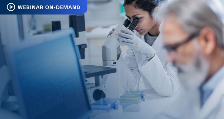 Webinar On-Demand. Photo of a busy lab with female researcher using microscope.