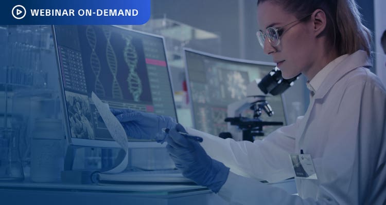 Webinar On-Demand. Photograph of researcher in a lab comparing data in a notebook to that on a computer display.