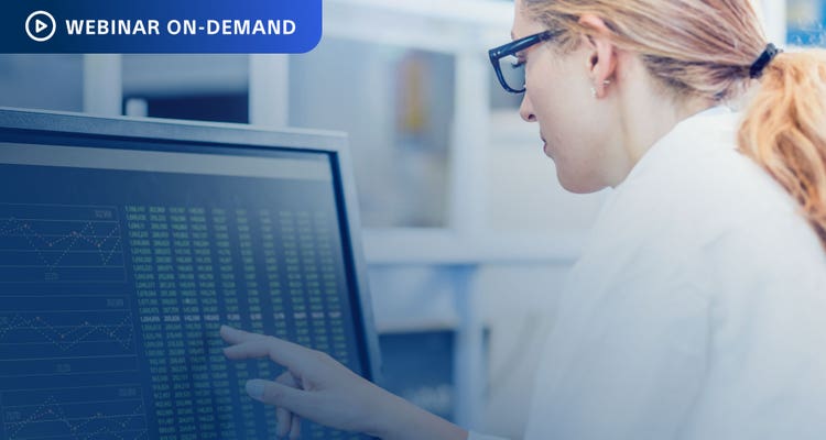 Webinar On-Demand. Photo of researcher in white coat analyzing data on a computer display.