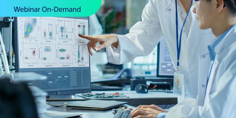 Webinar On-Demand. Photo of two researchers discussing cell sorting data on a computer display in a lab environment.
