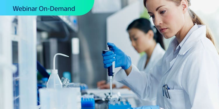 Webinar On-Demand. Photo of researcher in white coat using a pipetter with a tray of test tubes.
