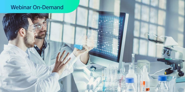 Webinar On-Demand. Two male researchers in a lab having a conversation while holding a beaker of blue liquid.