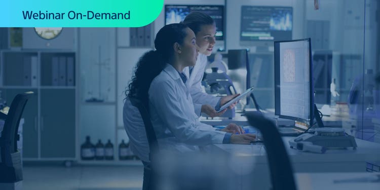 Two researchers looking at a computer display in a lab setting. Super-imposed text reading: Webinar On-Demand