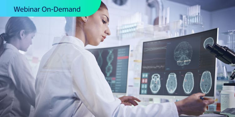 Webinar On-Demand. Two researchers working in a lab looking at genomics data on a computer display.