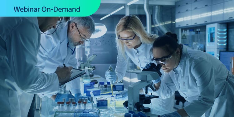 Webinar On-Demand Photo of researchers working around a table collaboratively.